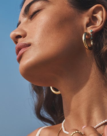 woman wearing gold hoop earrings