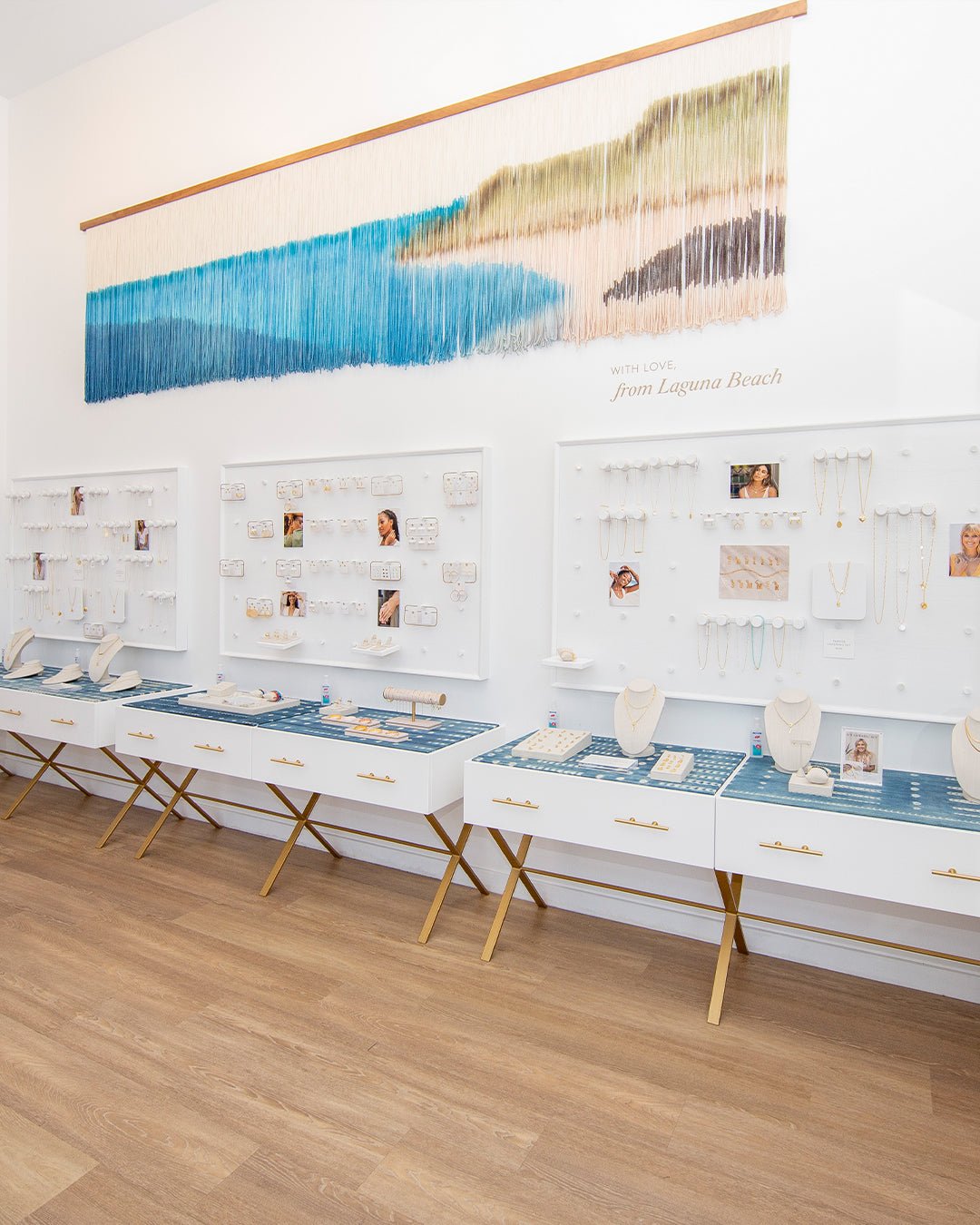 White wall of jewelry pegs and cases